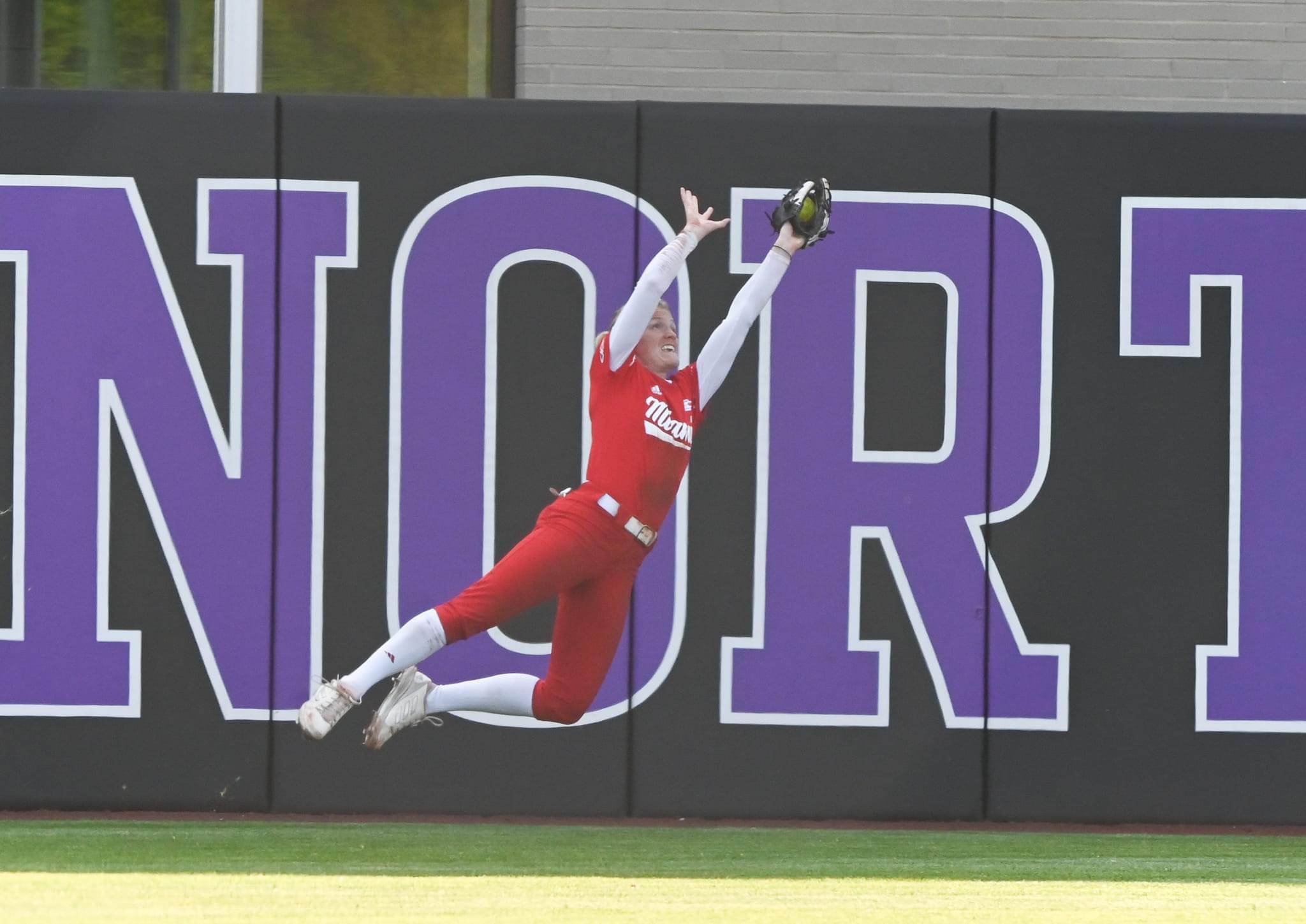 Maddi Banks making jumping catch in outfield